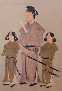 illustration of a man in a robe with a samurai sword, with two small robed women on each side of him.