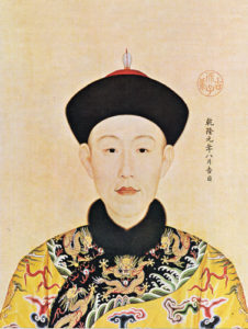 A painting depicting a young Qianlong emperor wearing a Qing emperor hat and a vibrant yellow imperial robe adorned with a dragon pattern. The painting showcases the regal attire of the emperor, symbolizing his imperial status and the rich cultural heritage of the Qing dynasty in China.