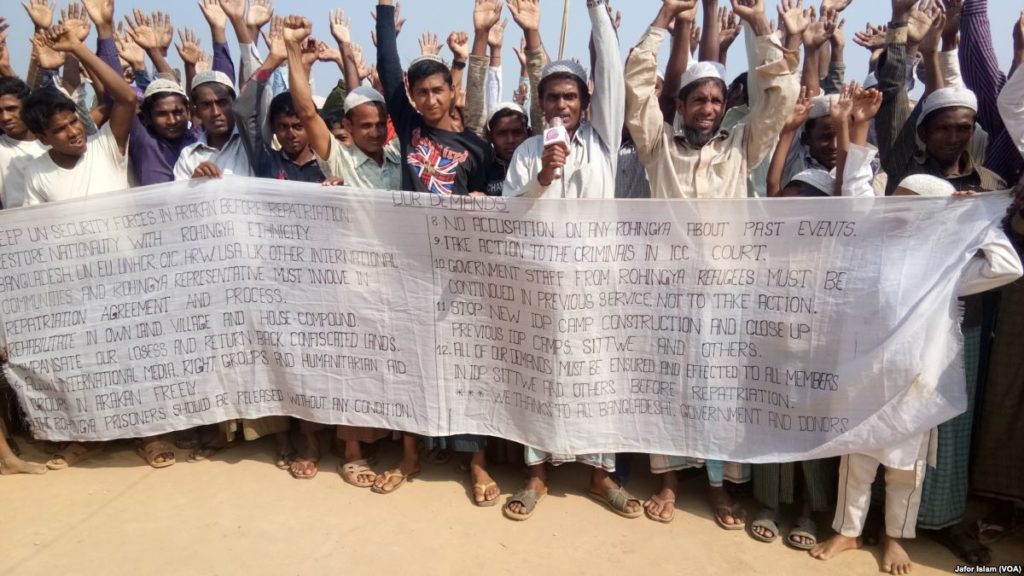 photo of a large group of people holding a protest banner