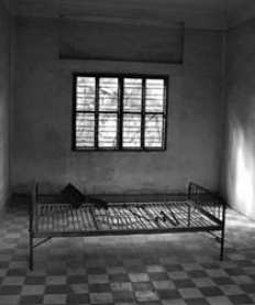 Image of S-21 prison torture room with a bed frame