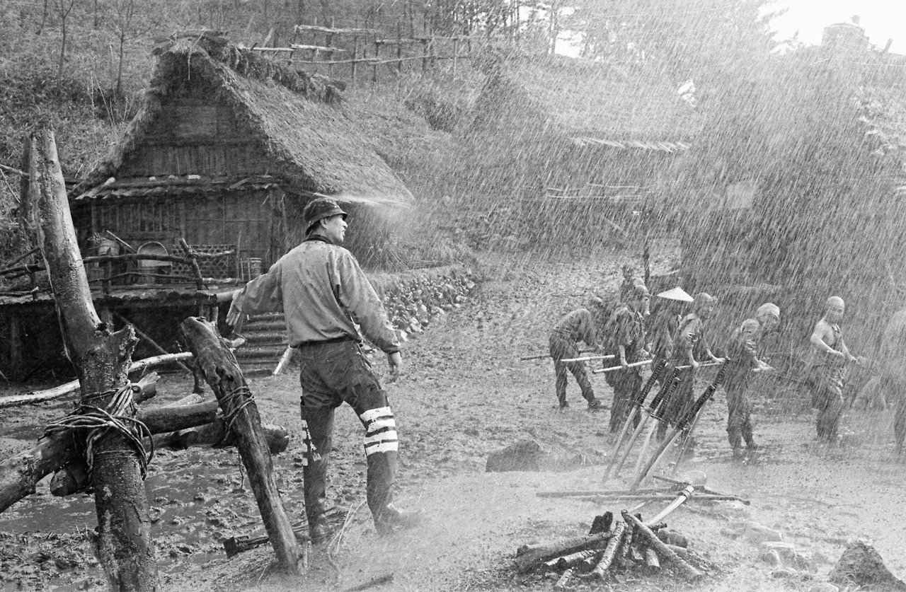 Kurosawa on location during the filming of the climactic rain-drenched battle scenes of Seven Samurai.