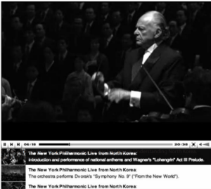 Screen capture shows a man conducting the performance 