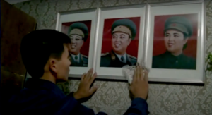 Mr. Hong dusting the portraits of the ruling Kim family.