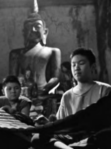 Image shows a boy sitting in the temple