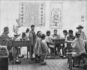 an illustration of a classroom, showing some scrolls on the wall and students at desks