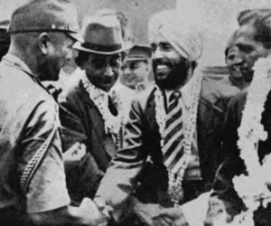 a picture of a man with a turban and military uniform shaking hands.