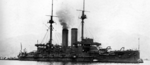 Image of a battleship with black smoke on the sea