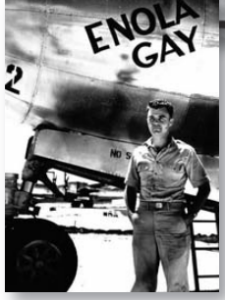 Image of a man standing before the Enola Gay