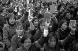 Image shows crowd of women with books in their hands