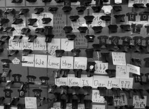 notes on a wall say "why we stay here? we love hong kong, hong kong is our home!