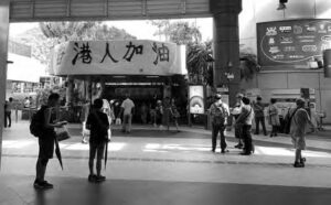 photo of people standing in the front of a subway station