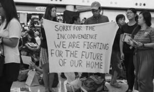 a photo of people with a sign that says "sorry for the inconvenience we are fighting for the future of our home