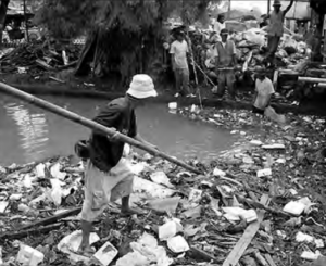 Image of a person trying to clear the waterway