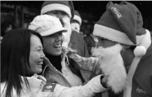 Two girls happily talking with Santa Claus