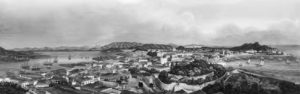 panorama of a landscape of hills and rivers. a church can be seen in the distance. 