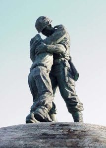 a statue of two men embracing each other emotionally