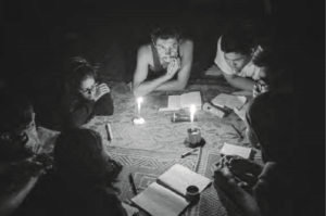 After a day’s trek near Kalaw, students and teacher write poems in a Pa-O home. They use candles as lights to see.