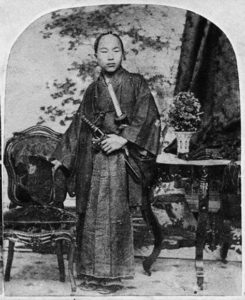 photo of a man in robes holding a katana