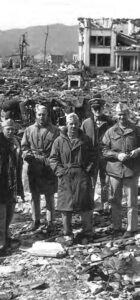 several men in military uniforms stand amidst rubble