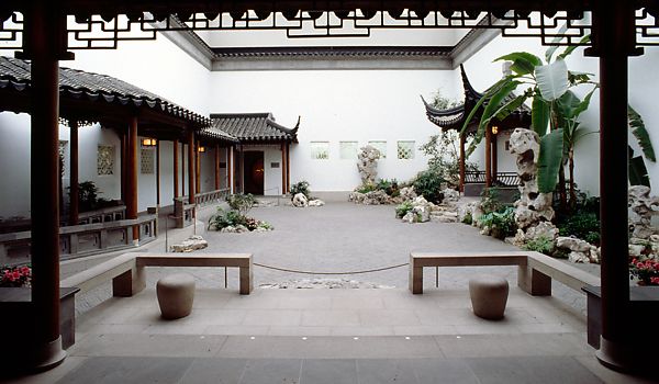 The Astor Court in the Metropolitan Museum of Art. The court shows a Chinese garden scene with a replica of pagodas, a koi fish pond, and bonsai trees. 