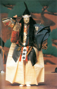 Photograph of the Atsumori play. Taira no Atsumori, the main character is shown in a traditional Heinan period samurai outfit and holding up a decorative fan in one hand. 