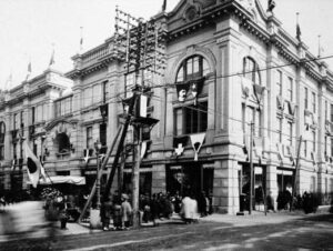 photo of a large building, with a japanese and other country flags visible