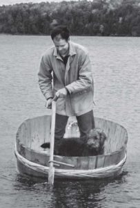 photo of a man in a large wooden bucket