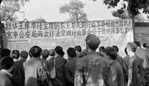 photo of a crowd gathered in front of a protest banner