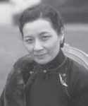 Photograph of Soong Mei-ling. She is a middle aged woman wearing a simple cheongsam and is smiling at the camera. 