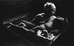 Tomoko and Mother in the Bath is a photograph taken by American photojournalist W. Eugene Smith in 1971. Many commentators regard Tomoko as Smith's greatest work. The black-and-white photo depicts a mother cradling her severely deformed, naked daughter in a traditional Japanese bathroom. The mother, Ryoko Kamimura, agreed to deliberately pose the startlingly intimate photograph with Smith to illustrate the terrible effects of Minamata disease (a type of mercury poisoning) on the body and mind of her daughter Tomoko Kamimura. 