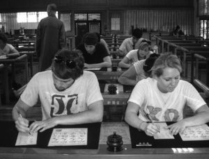 Students practicing contemplative calligraphy at Foguangshan Monastery, Taiwan.