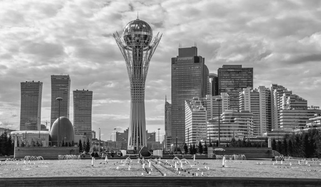 A city park with a large circular sculpture in the middle. 