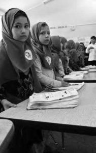 photo of young women at desks