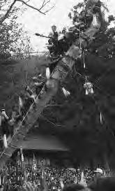 a large group of people erecting a pillar