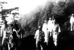 several people in white climb up a mountain