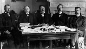 a photo of several men in suits sitting together 