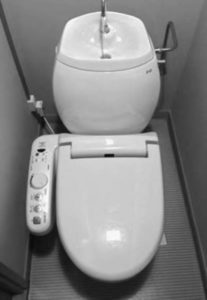 Image of Japanese toilet with a sink mounted on top of the water tank