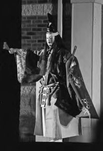 A picture of Gary Mathews as nochi-shite in the play "Atsumori." He is wearing a traditional Heinan period samurai suit and sword. 