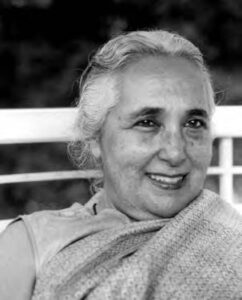 Photograph of the face of Romila Thapar, a middle aged woman smiling radiantly. 