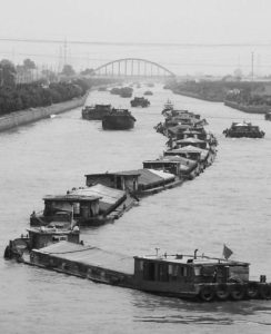 Jiangnan canal, with several boats in the water.