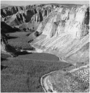 grain fields in valleys between mountains in China.