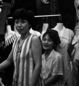 photo of a woman and her daughter among clothing mannequins