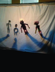 A simple puppet show with four figures. 