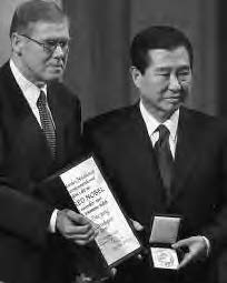 two men hold an award