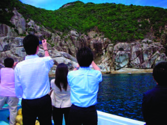 photo of people taking photos of a shoreline