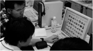 Three students look at an online image database. 