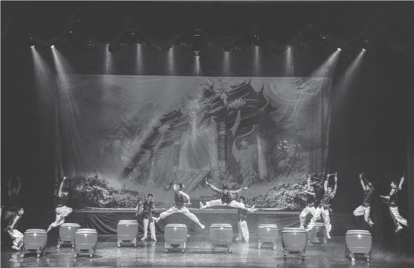 The image shows dancers doing stage performance