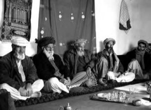 a photo of several men in turbans sitting down