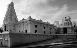 photo of a tample showing two of its entrances and the tall tower at the front