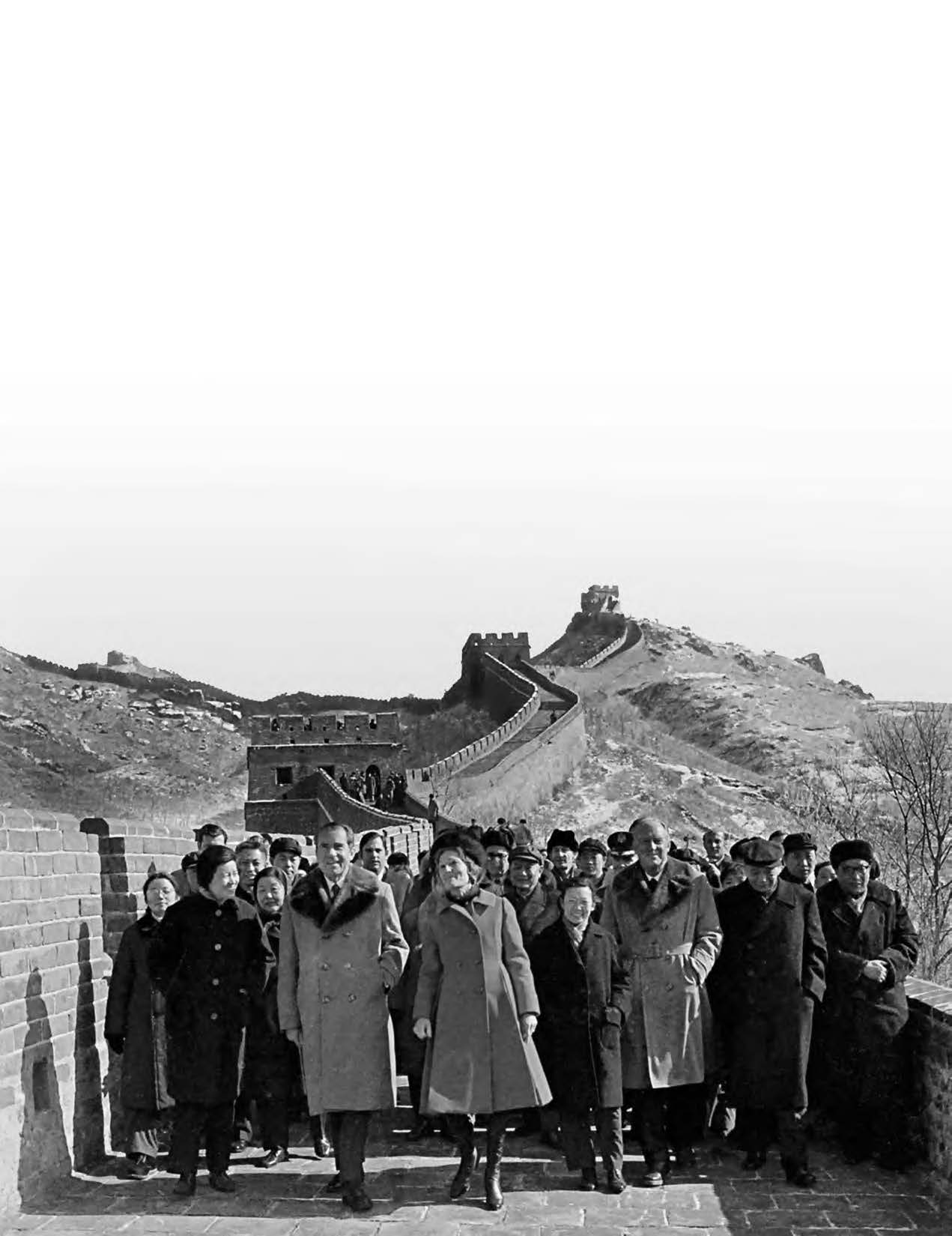 a group of people in front of a great wall